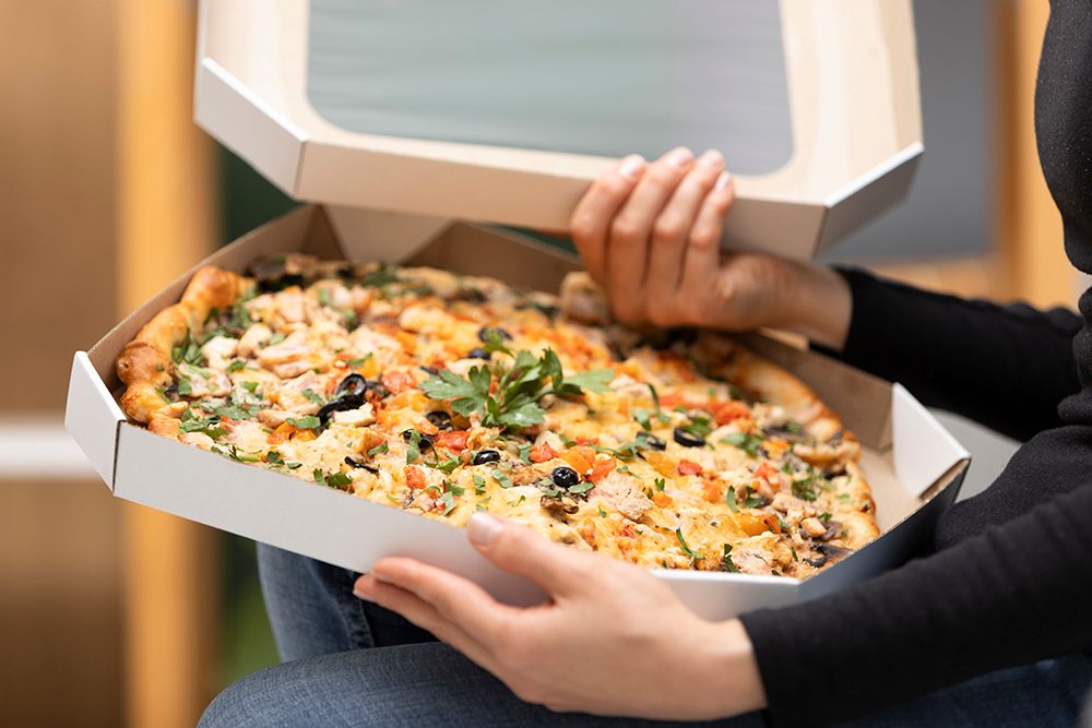 close-up-hands-holding-pizza-boxes.jpg