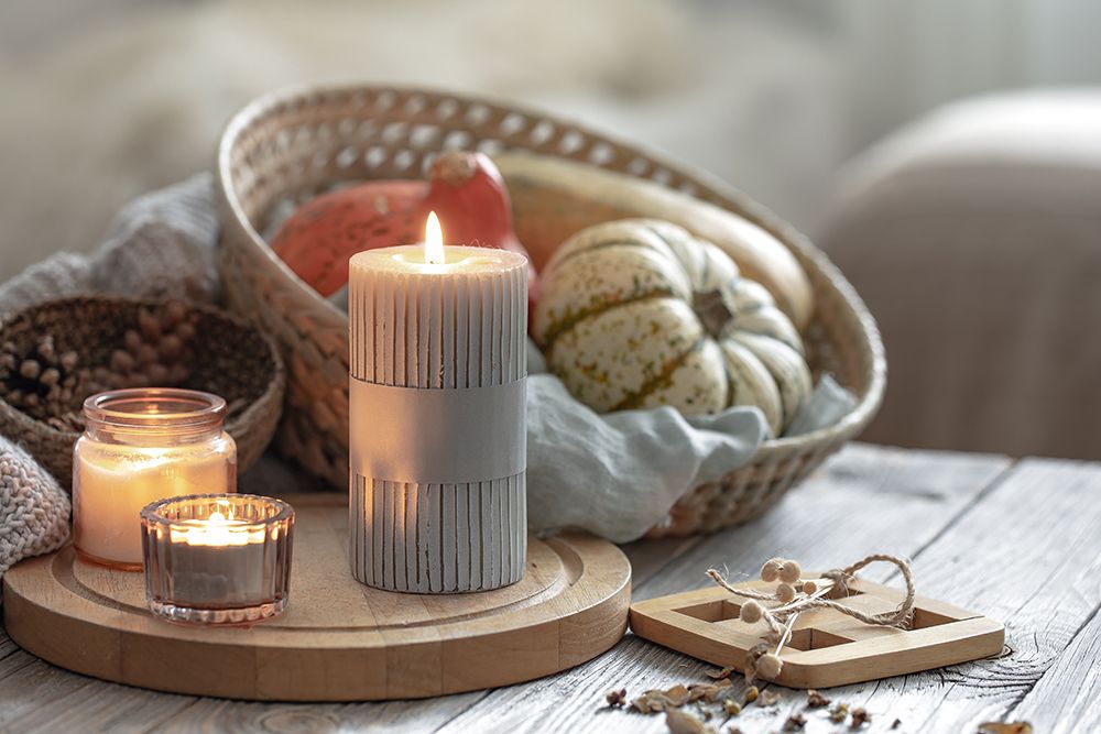 cozy-autumnal-composition-with-burning-candles-and-pumpkins-on-a-blurred-background.jpg